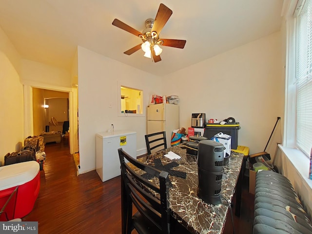 dining area featuring dark wood-type flooring and ceiling fan