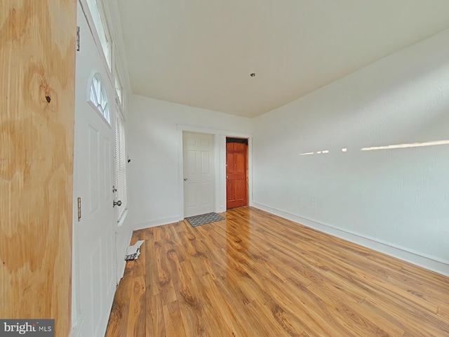 unfurnished bedroom featuring light wood-style flooring and baseboards