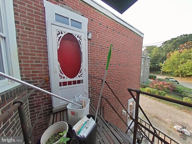 view of exterior entry with brick siding