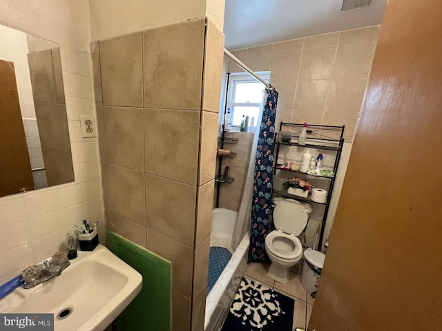 bathroom featuring tile walls, toilet, tile patterned flooring, and sink