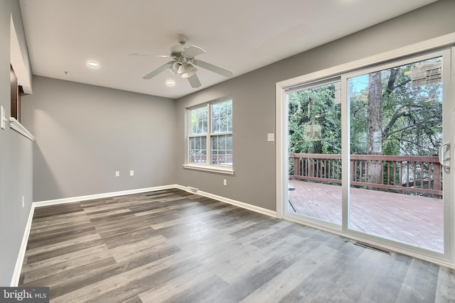 empty room with ceiling fan and wood-type flooring