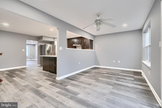 unfurnished room featuring ceiling fan and hardwood / wood-style floors