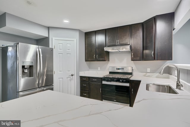 kitchen featuring sink, dark brown cabinetry, appliances with stainless steel finishes, and light stone counters