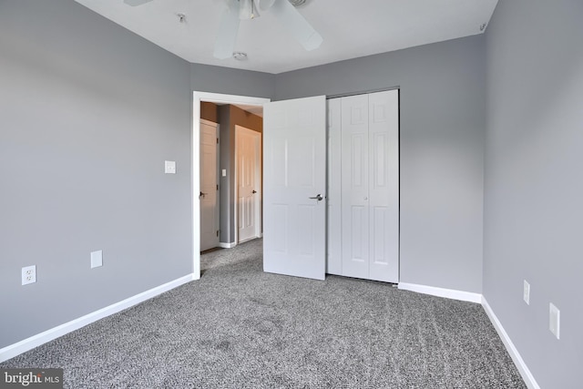 unfurnished bedroom with ceiling fan, carpet flooring, and a closet