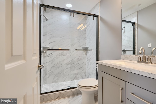 bathroom featuring tile patterned flooring, vanity, walk in shower, and toilet