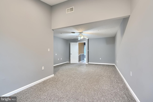 carpeted spare room with ceiling fan