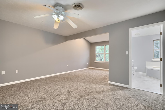 unfurnished room with ceiling fan and carpet