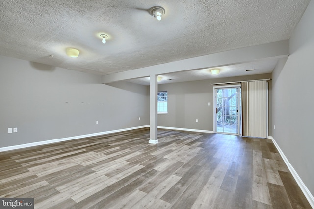 empty room featuring hardwood / wood-style flooring and a textured ceiling