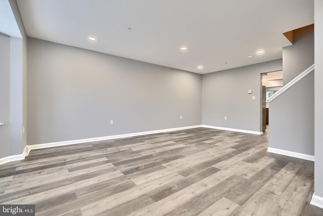 spare room with wood-type flooring