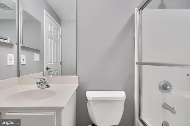 full bathroom with vanity, shower / bath combination with glass door, and toilet