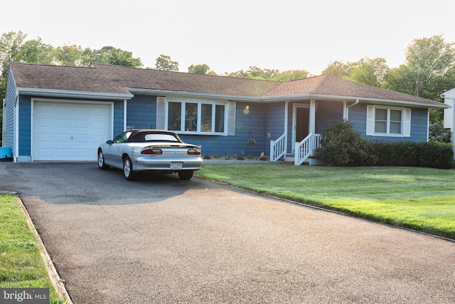 ranch-style home with a garage and a front lawn