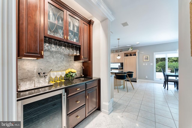 bar with sink, beverage cooler, backsplash, light tile patterned floors, and ornamental molding