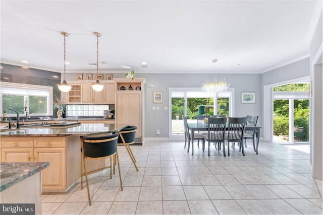 kitchen with a healthy amount of sunlight, light brown cabinetry, and stone counters