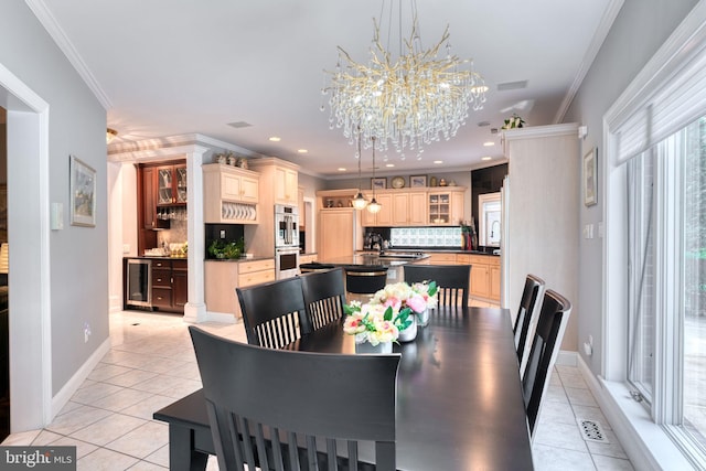 dining room featuring ornamental molding, wine cooler, a chandelier, and light tile patterned floors