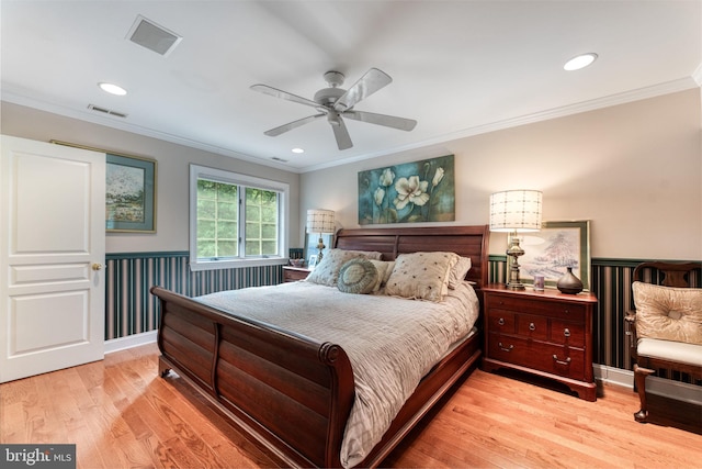 bedroom with light wood-type flooring, ornamental molding, and ceiling fan