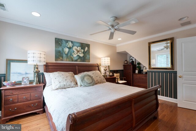 bedroom featuring ceiling fan, crown molding, and hardwood / wood-style floors