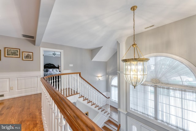 corridor featuring a chandelier and hardwood / wood-style flooring