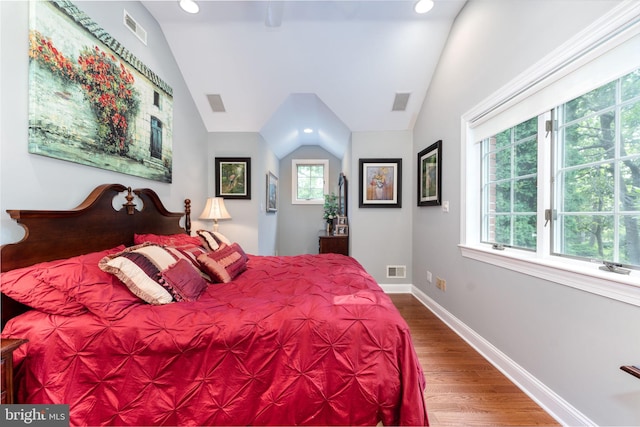 bedroom with lofted ceiling and hardwood / wood-style flooring