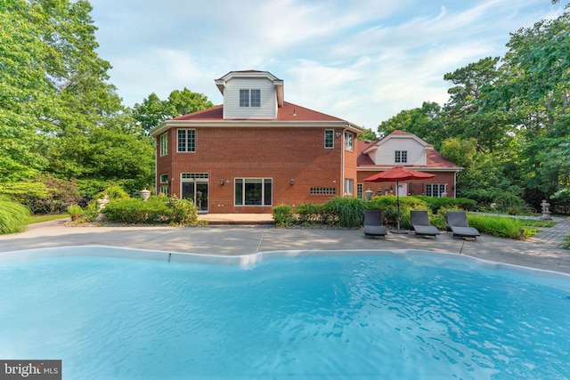 view of swimming pool with a patio area