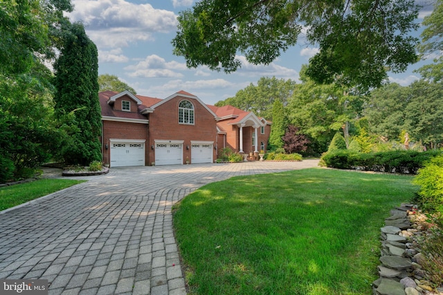 view of front of house featuring a garage and a front lawn