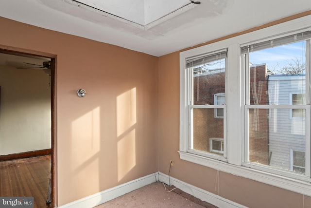 unfurnished room featuring ceiling fan and hardwood / wood-style flooring