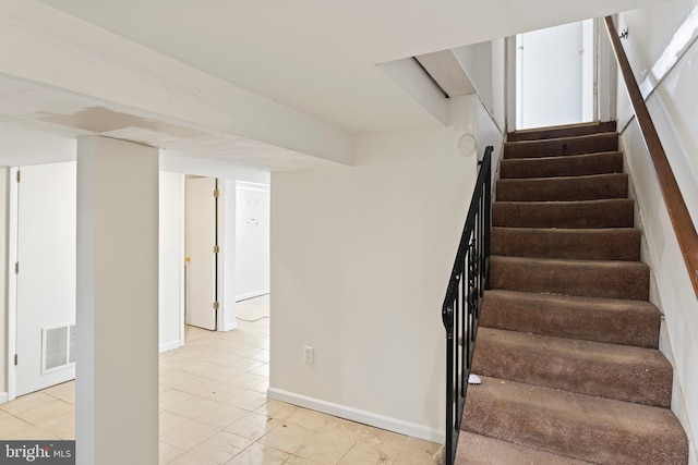 stairway featuring tile patterned flooring