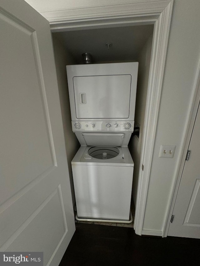 laundry area featuring stacked washer / dryer