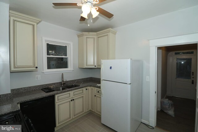 kitchen featuring black dishwasher, white fridge, cream cabinets, ceiling fan, and light tile patterned floors