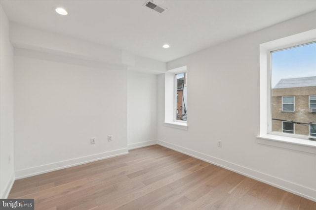 spare room with light hardwood / wood-style floors