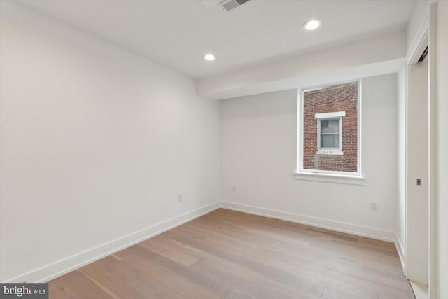 unfurnished room with light wood-type flooring