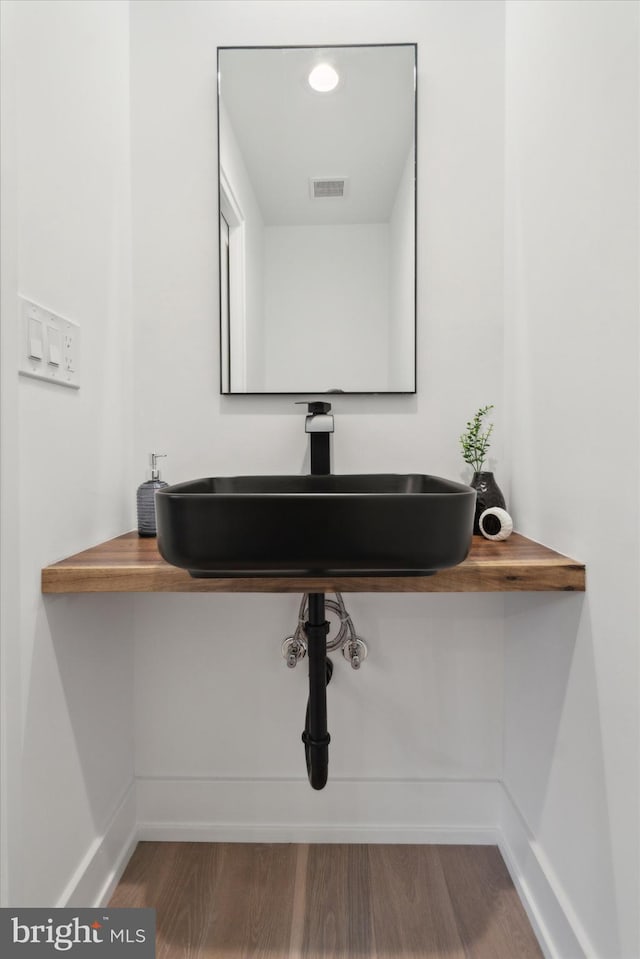 bathroom with hardwood / wood-style floors and sink