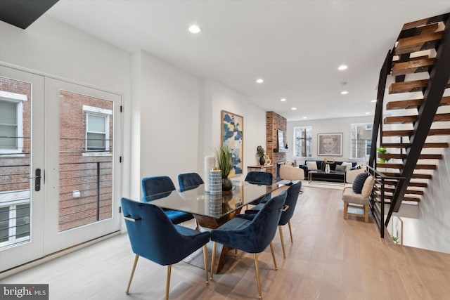 dining room with french doors and light hardwood / wood-style floors