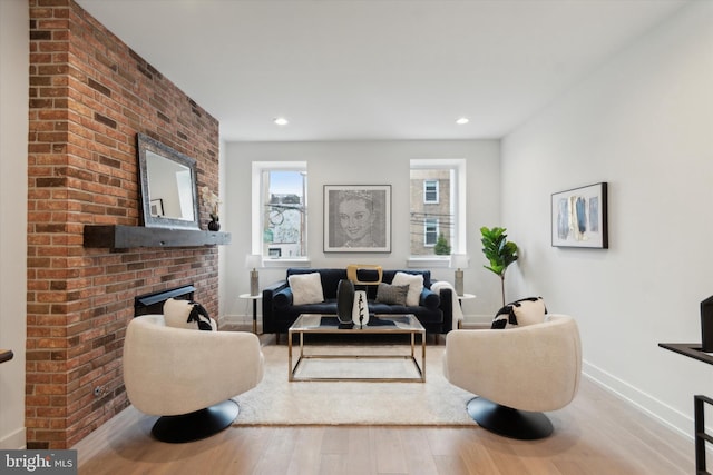 living room with light wood-type flooring and a fireplace