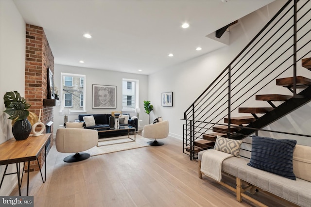 living room with light hardwood / wood-style flooring and a fireplace