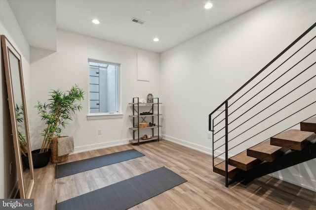 exercise area featuring light hardwood / wood-style flooring