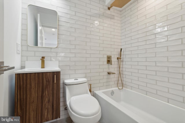 full bathroom featuring tiled shower / bath, vanity, tile walls, and toilet