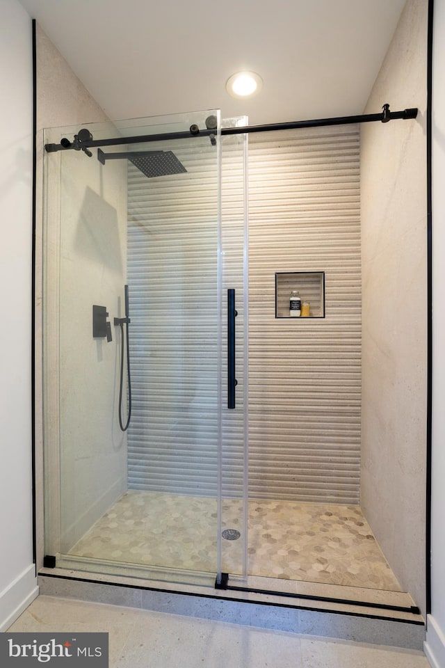 bathroom with a shower with door