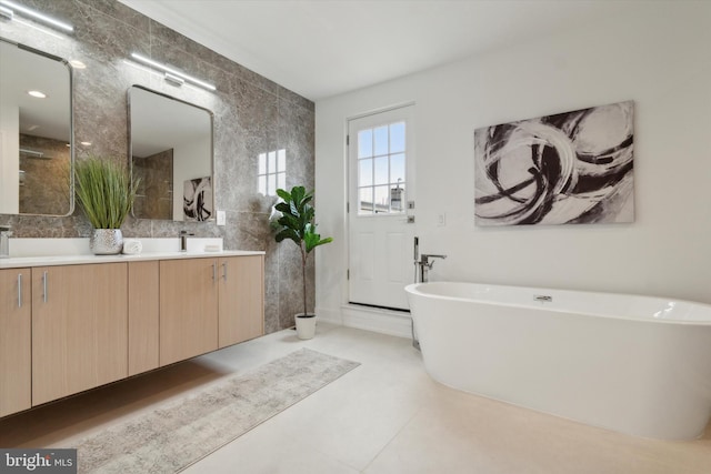 bathroom featuring plus walk in shower, tile walls, tile patterned flooring, and vanity