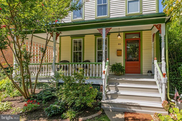 view of exterior entry featuring a porch