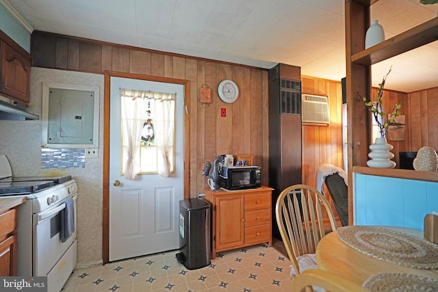 kitchen with wooden walls, electric panel, white gas range oven, and light tile patterned floors