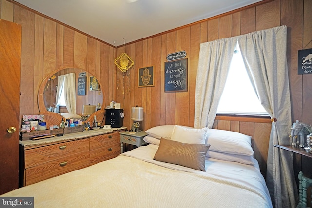 bedroom featuring wooden walls