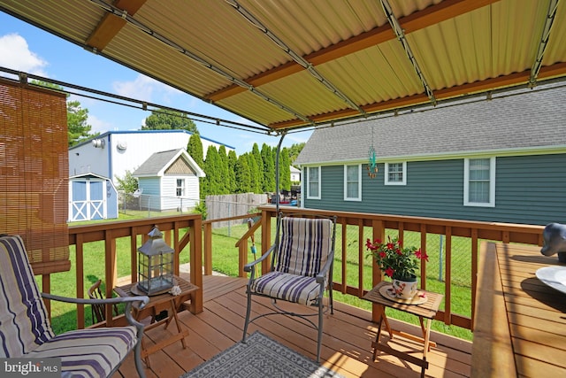 wooden terrace with fence private yard, a storage shed, an outbuilding, and a yard