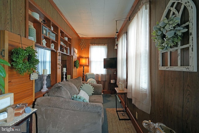 interior space featuring wooden walls and crown molding