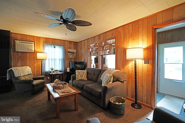 living room featuring ceiling fan, carpet flooring, wood walls, and a wall mounted AC