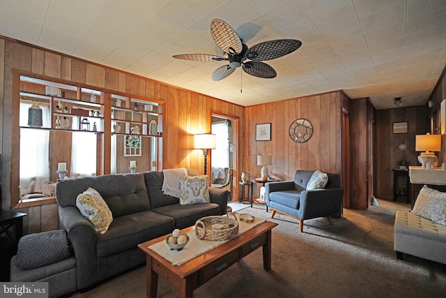 living room with carpet flooring, ceiling fan, and wooden walls