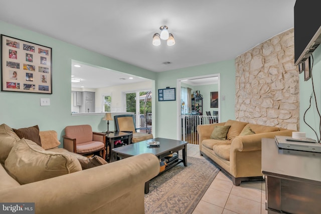 living area featuring light tile patterned floors, visible vents, and recessed lighting