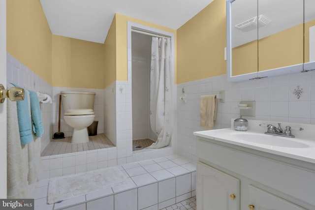 bathroom featuring visible vents, a stall shower, toilet, and tile walls