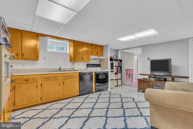 kitchen featuring under cabinet range hood, light countertops, electric range oven, black dishwasher, and a sink