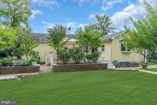 exterior space featuring a front lawn and a patio