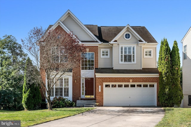 view of front of home with driveway, brick siding, an attached garage, and a front yard